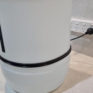 Large white barrel with measurement scale and power cord.